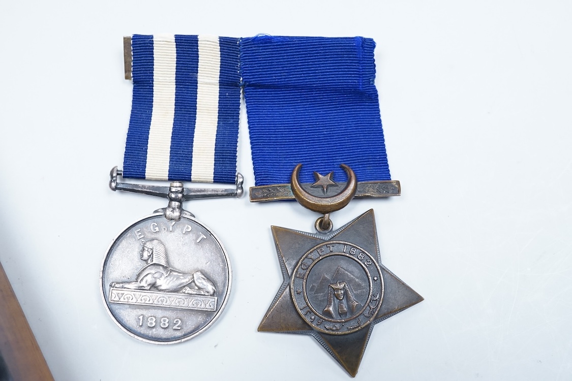 An Egyptian campaign pair awarded to Midshipman C.E.E. Carey RN, comprising the Egypt campaign medal 1882 and the Khedives Star, Khedive's star 1882 unnamed, Associated cased set of chart instruments the lid with plaque